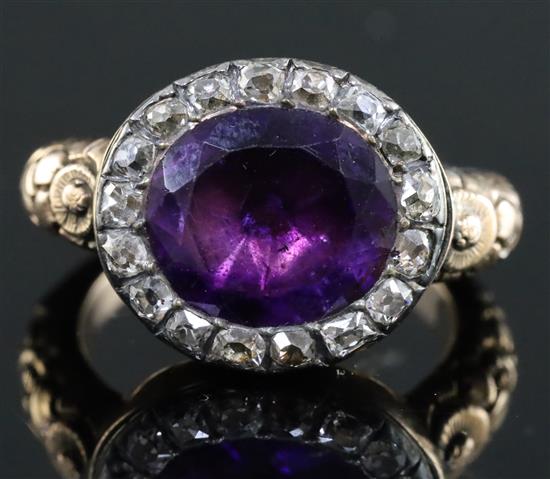 A George III gold, foil backed amethyst and diamond set oval ring, size L.